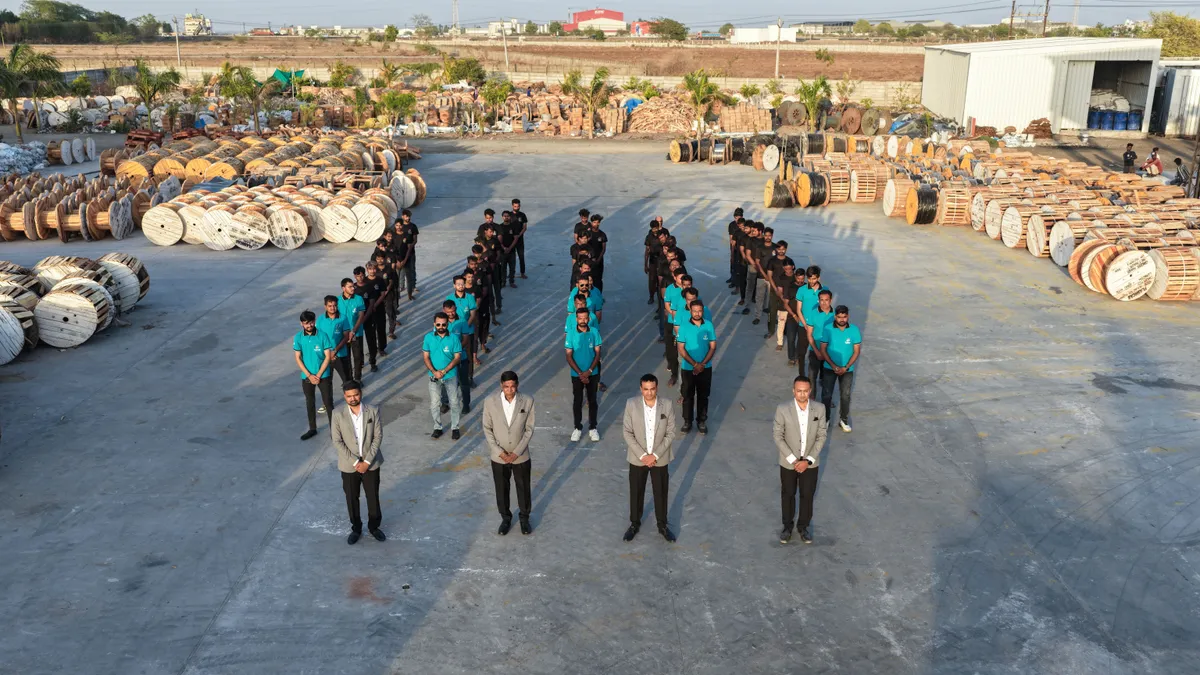 Flashcab Cables team standing in formation with cable drums